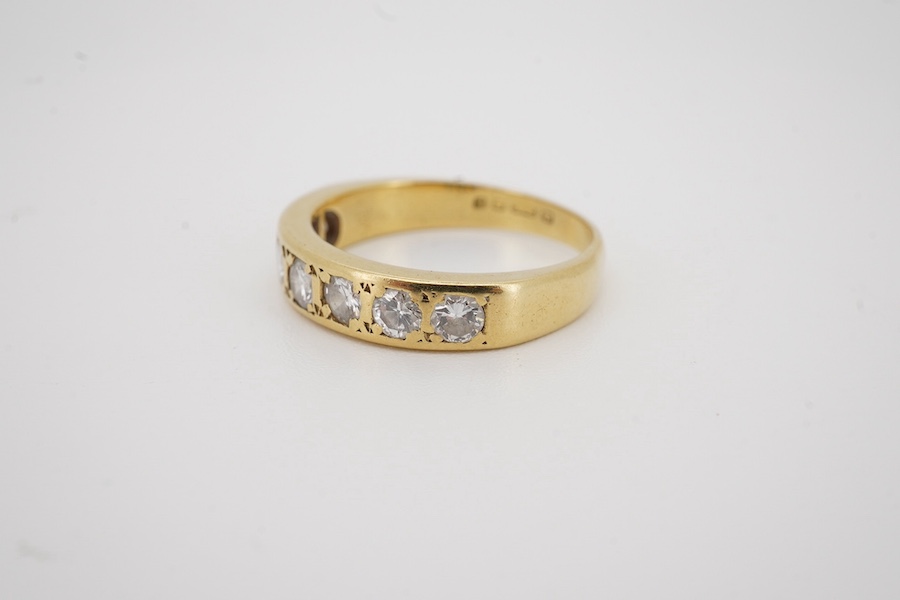 A modern 18ct gold and seven stone diamond set half hoop ring, size M, gross weight 4 grams.